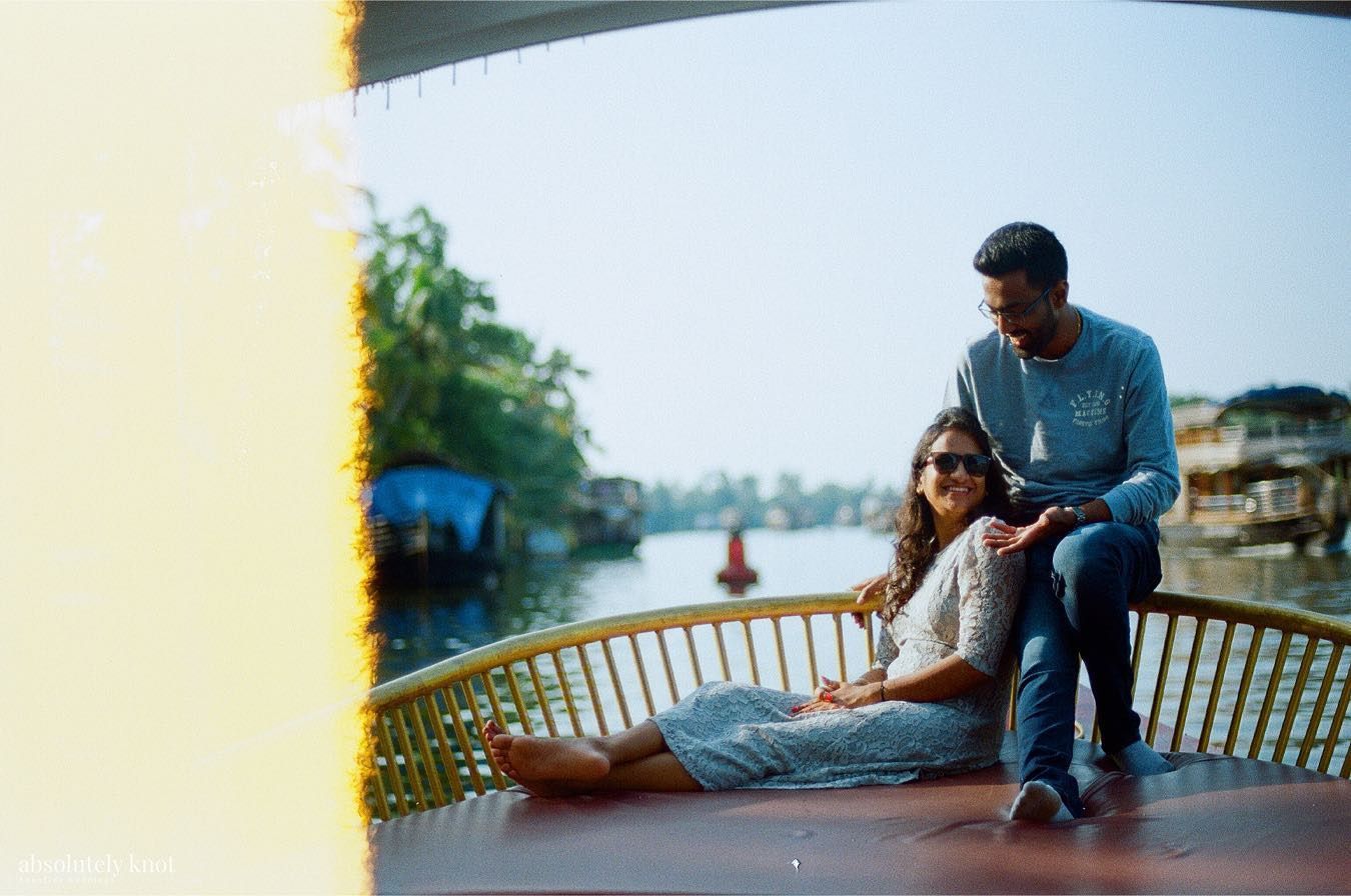 The first frame of a roll, a light leak spilling across a couple on a boat