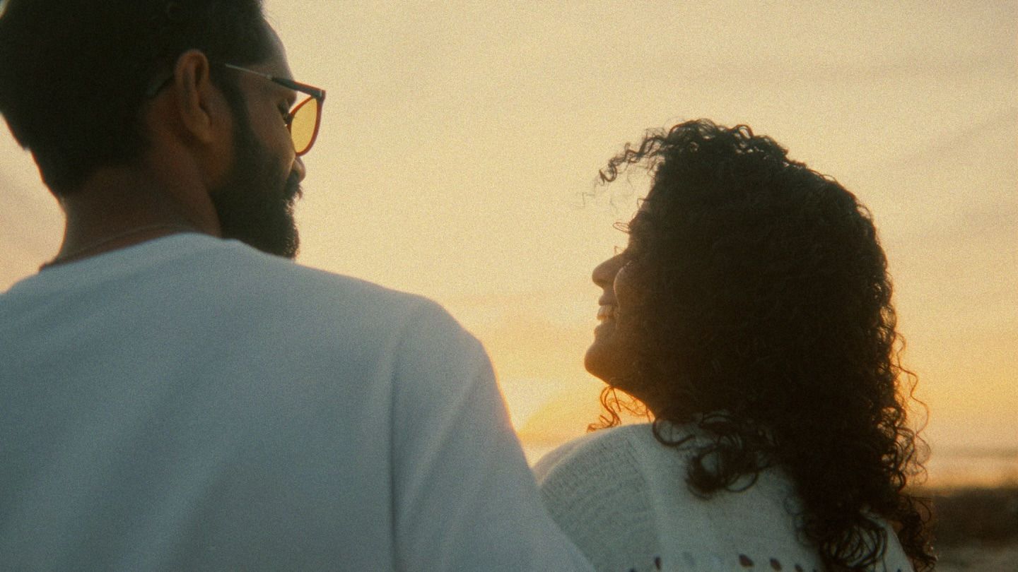 A couple silhouetted against a sunset