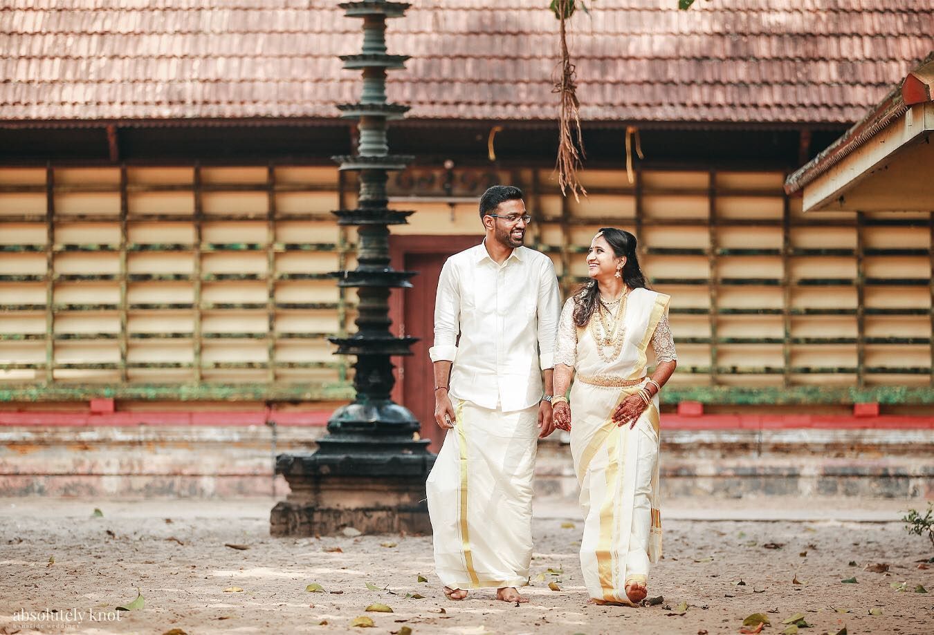 A couple walking in front of a traditional tiled building