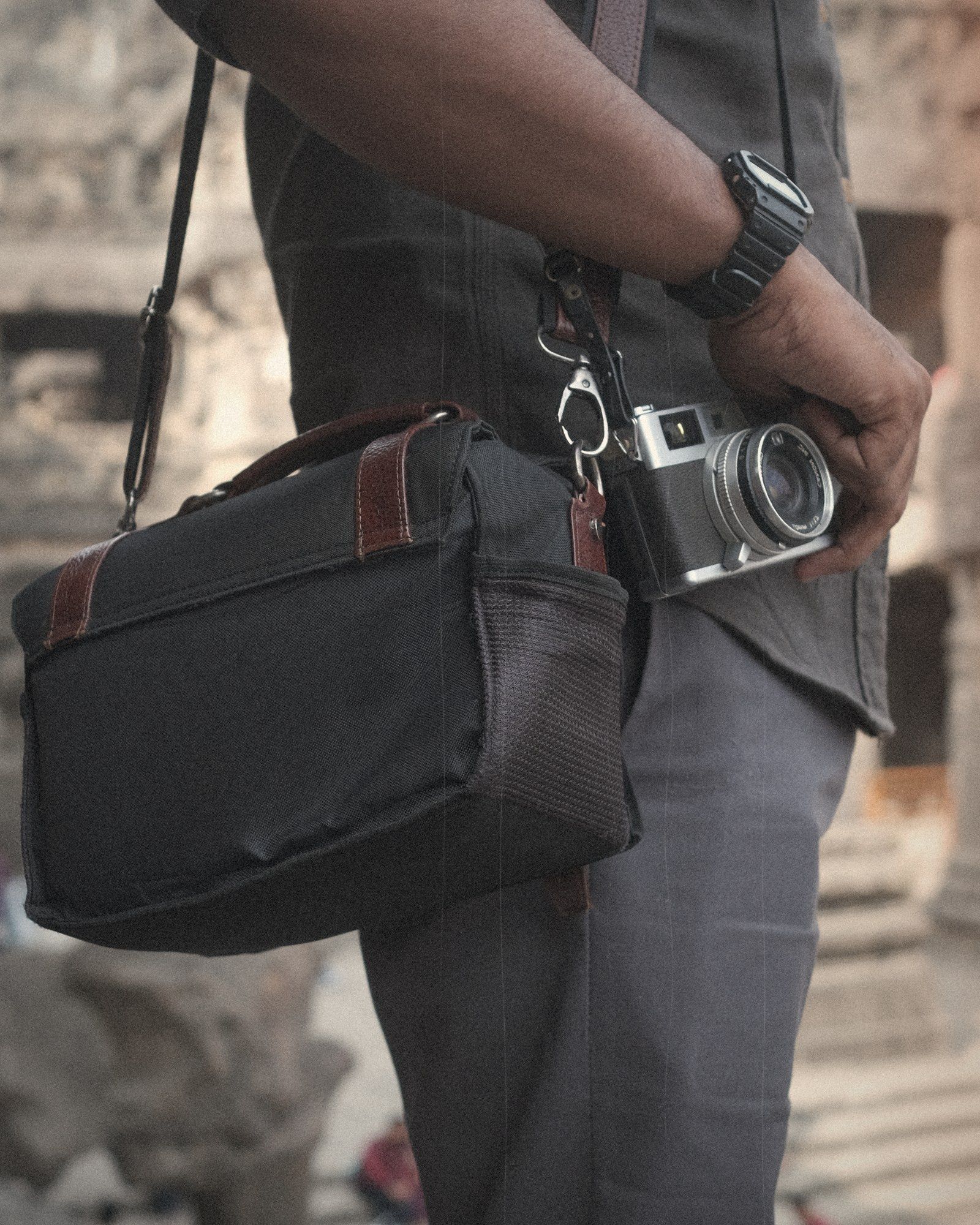 Behind the scenes: an old rangefinder camera in hand, with the camera bag on the shoulder